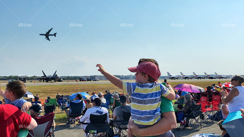 Little boy and father watching airplanes 