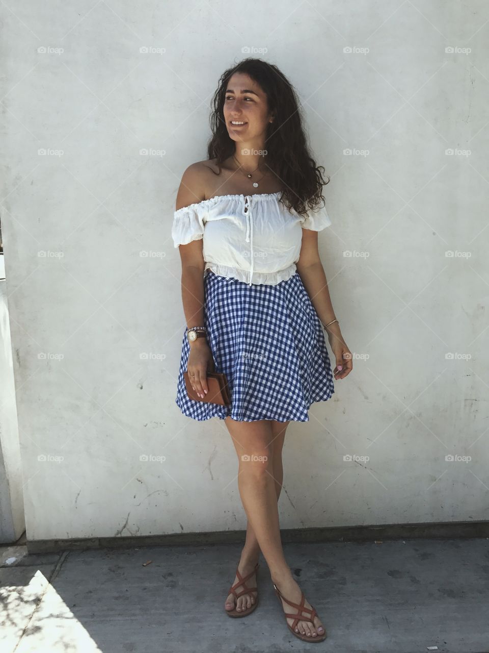 Girl in a plaid picnic skirt on a sunny day 