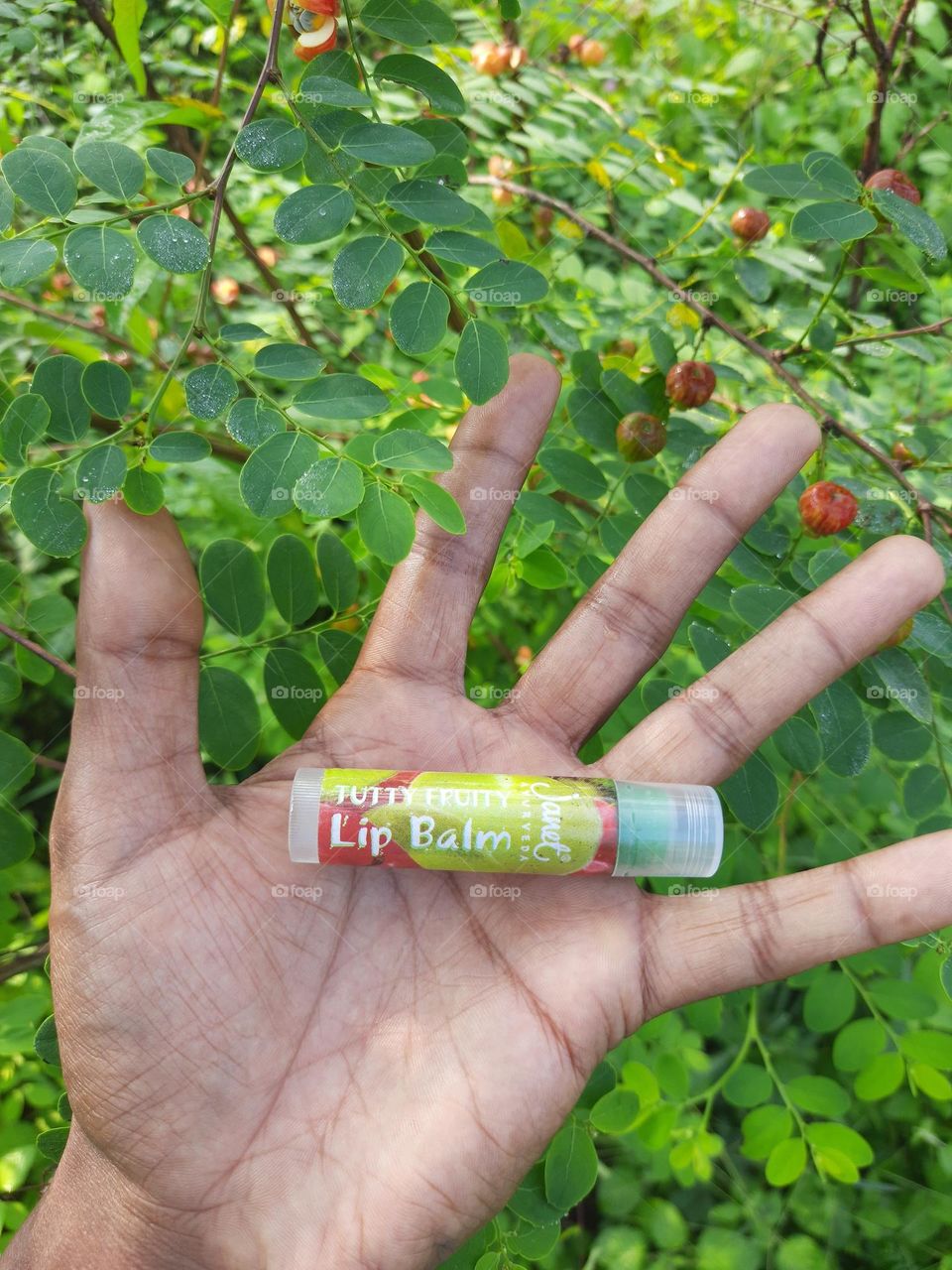janet Tutti fruity Natural lip balm in my hand.