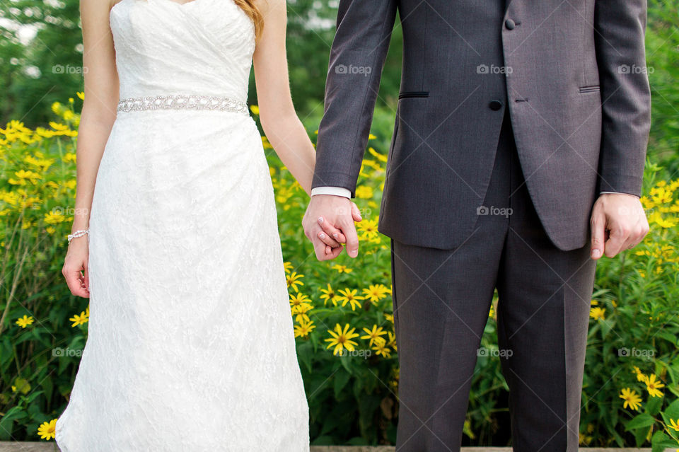 Bride and groom holding hands