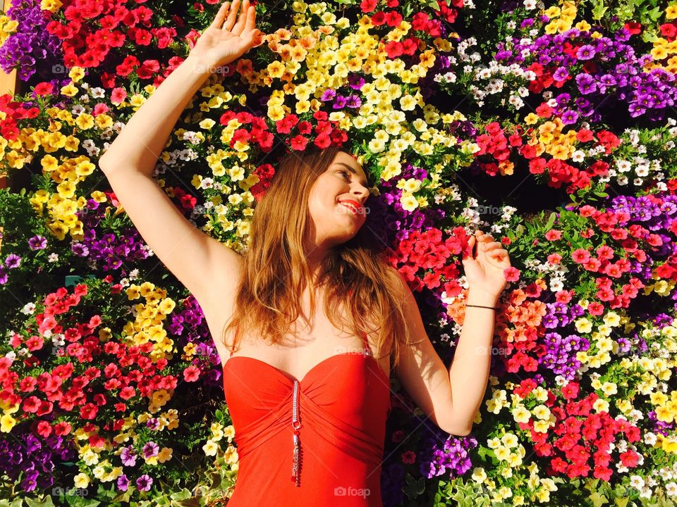 Woman standing against beautiful flower