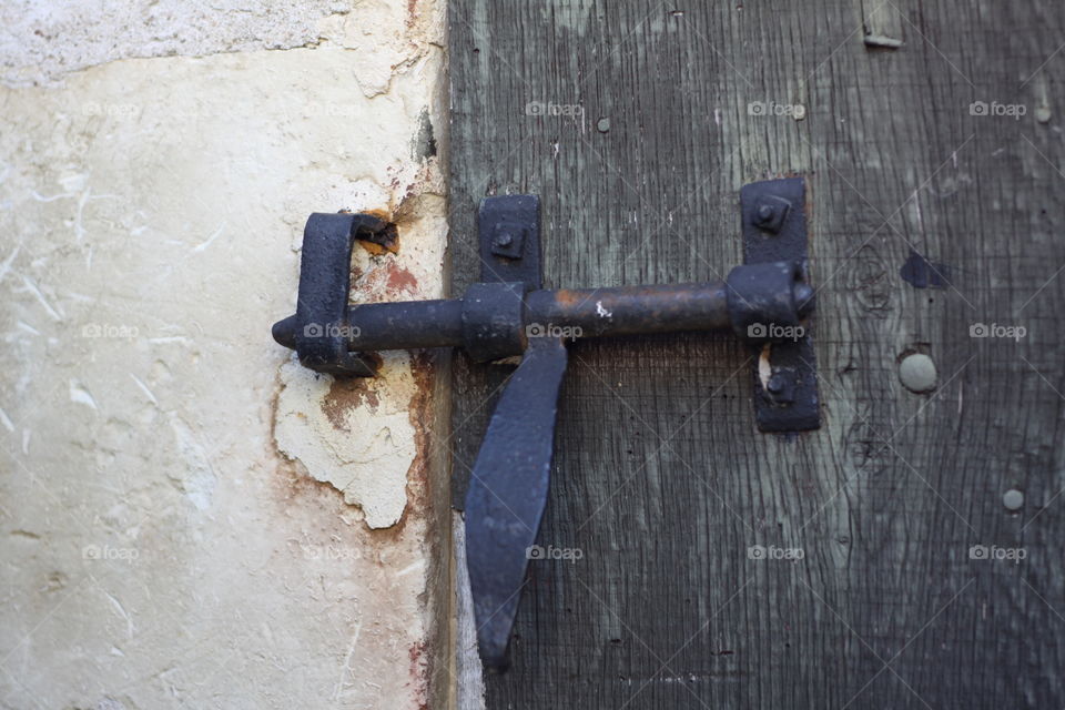 Latch . Old rusty latch on wooden door 