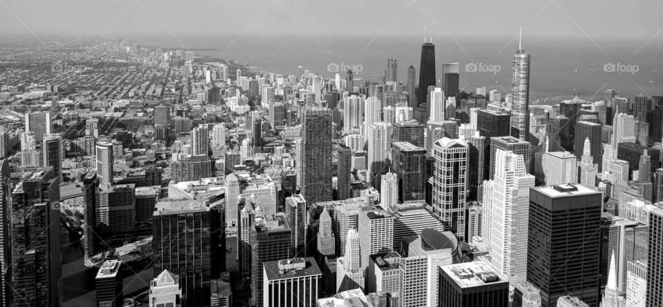 Black and white aerial shot of sprawling Chicago skyline.