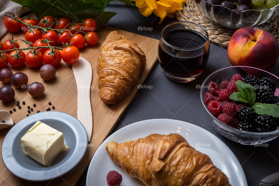 Delicious croissant in plate with berries