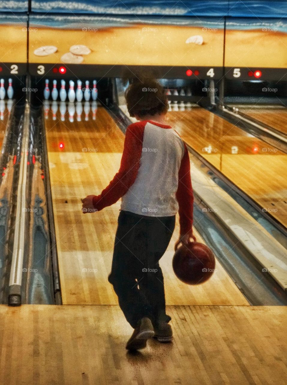 Little Boy At A Bowling Alley. American Bowling Alley
