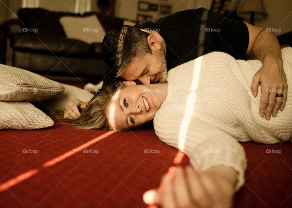Couple playing on the living room floor