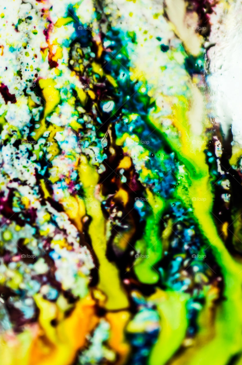 The ink to refill the printer cartridge was spilled onto the white washbasin and the paints blended into abstract drips and patterns