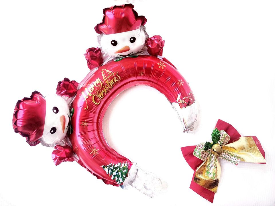 Snowman Christmas headband and Christmas bow on white background horizontal composition.