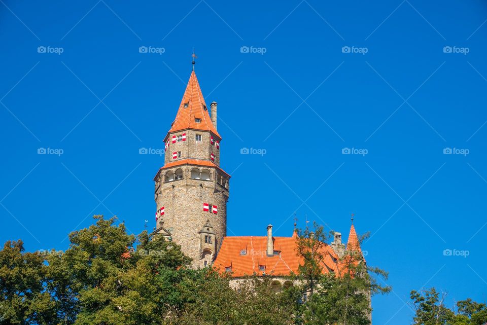 The famous Czech castle Bouzov with a typical roof and shutters.