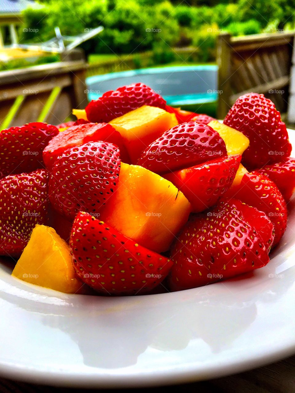 Strewberry and Mango in bowl outdoors