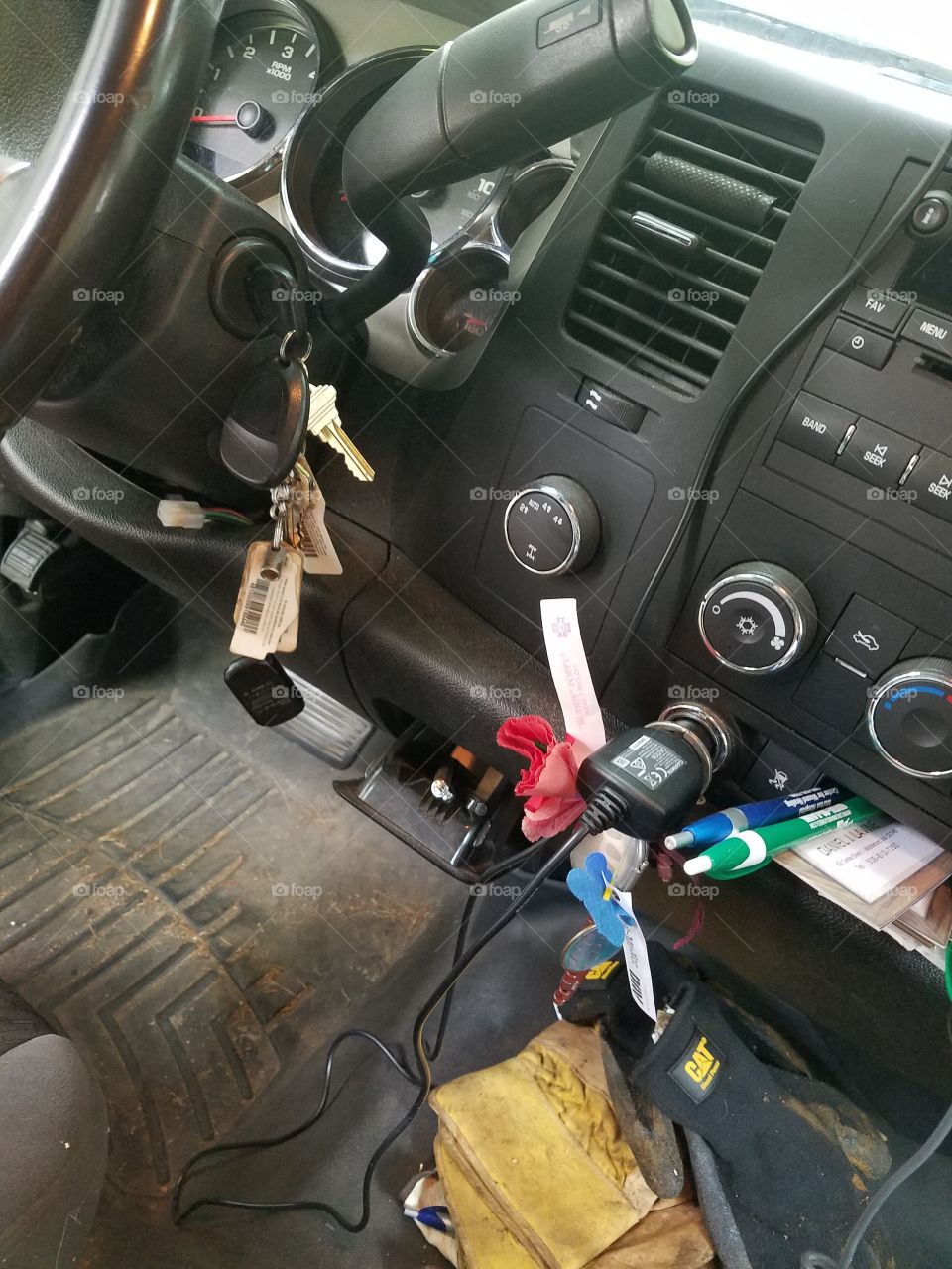 Working Mans truck front seat with keys in ignition ready to go.