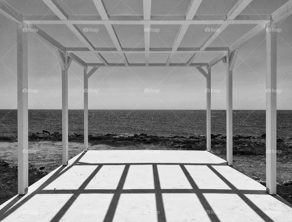 view of the sea through a geometric patio