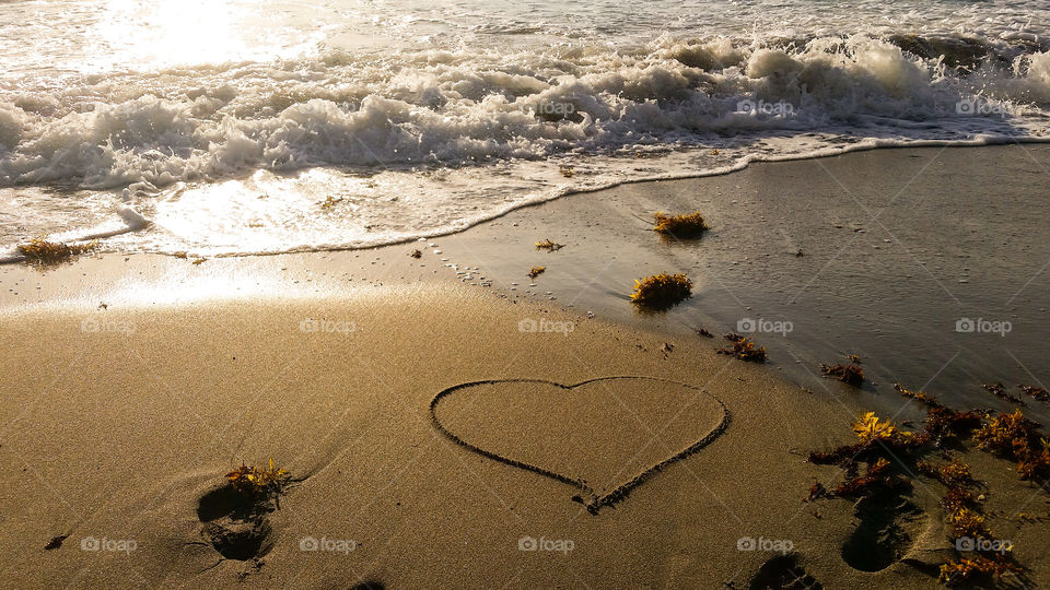 Heart shape drawn on the sand