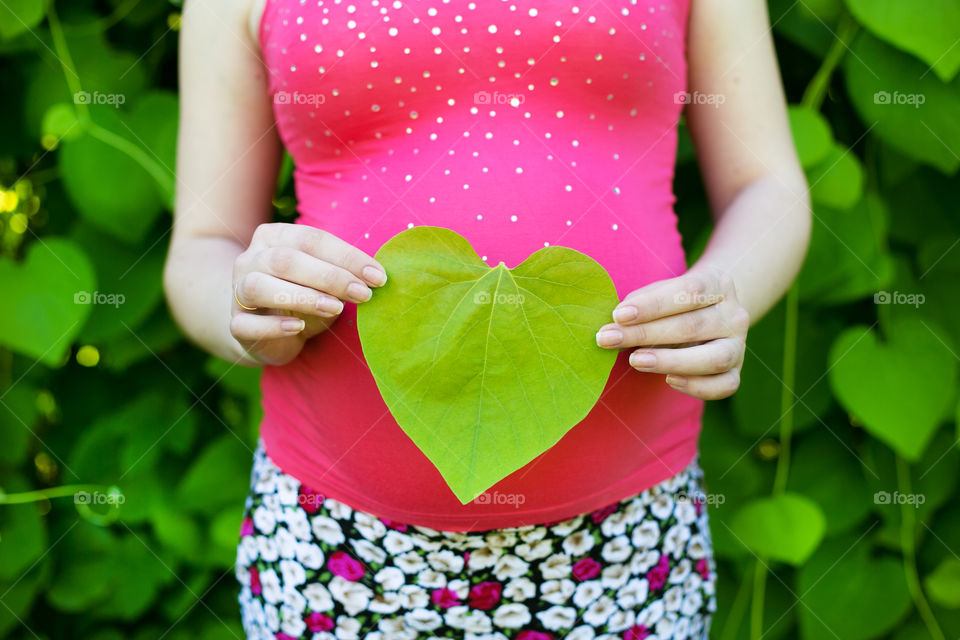 Beautiful pregnant girl. Cute pregnant girl on the nature 