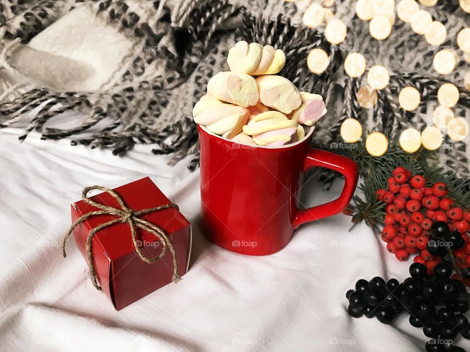 Coffee with marshmallows in white cozy bed 