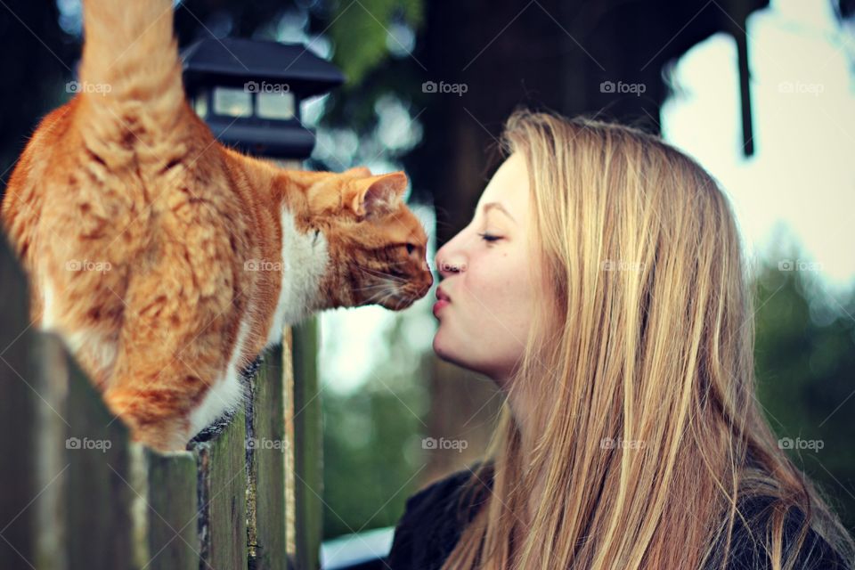 Woman and cat looking at each other