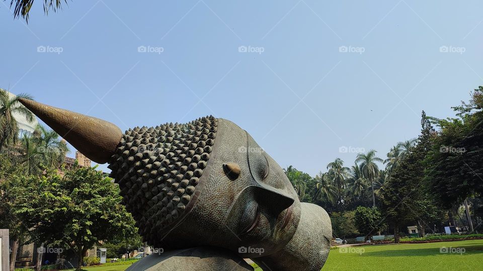 Random Buddha Head Statue lying in a ground