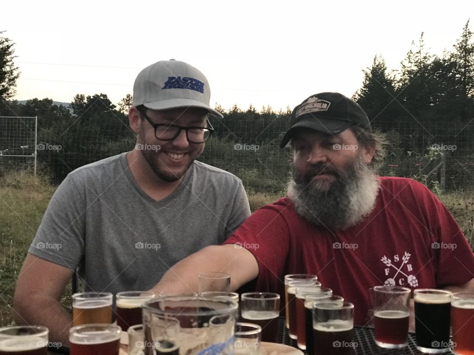 Craft beer maker gives details to customer about the beers he ordered.