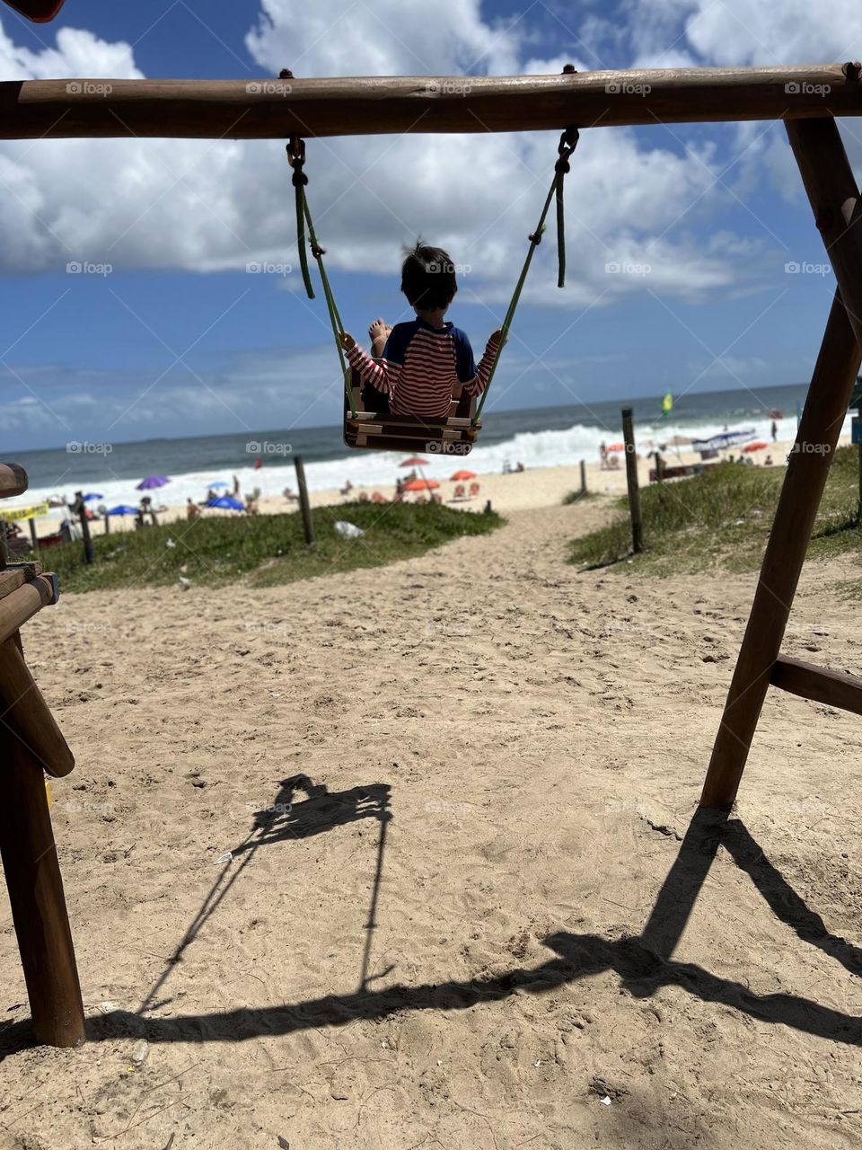 child bouncing at beach