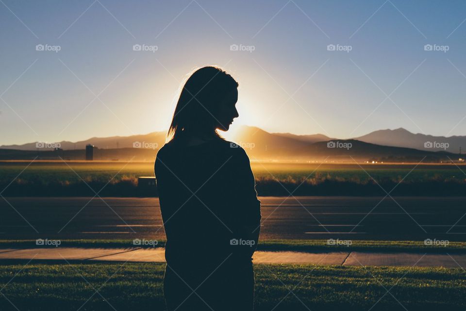 Silhouette of women standing in sunset