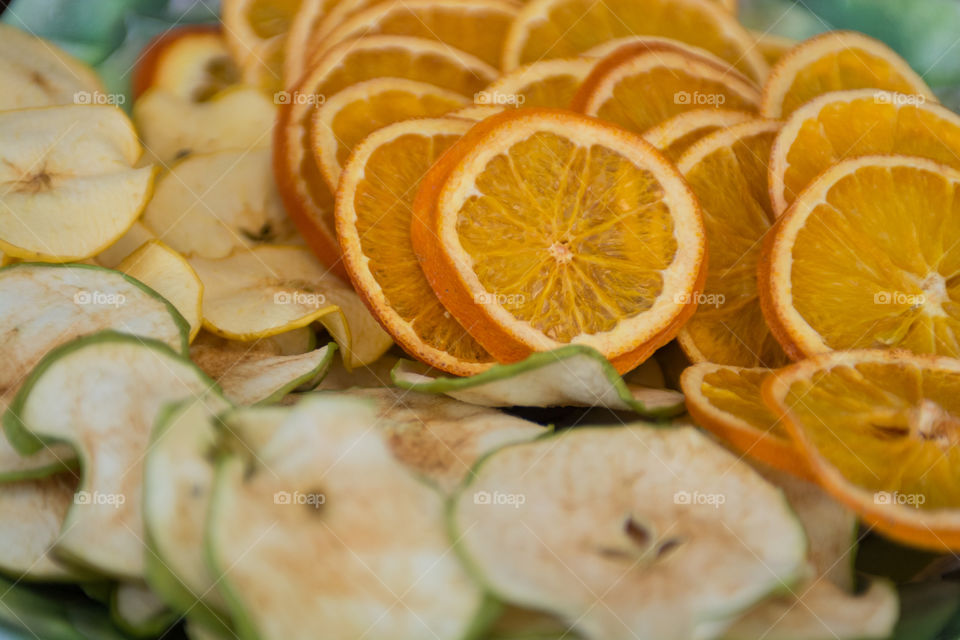 Orange slices and apple slices pieces of fruit laid out for a summer snack 