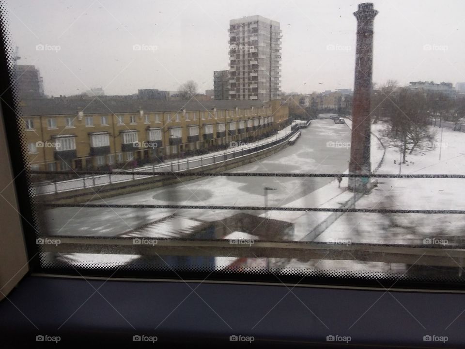 Snow in London captured from a moving train