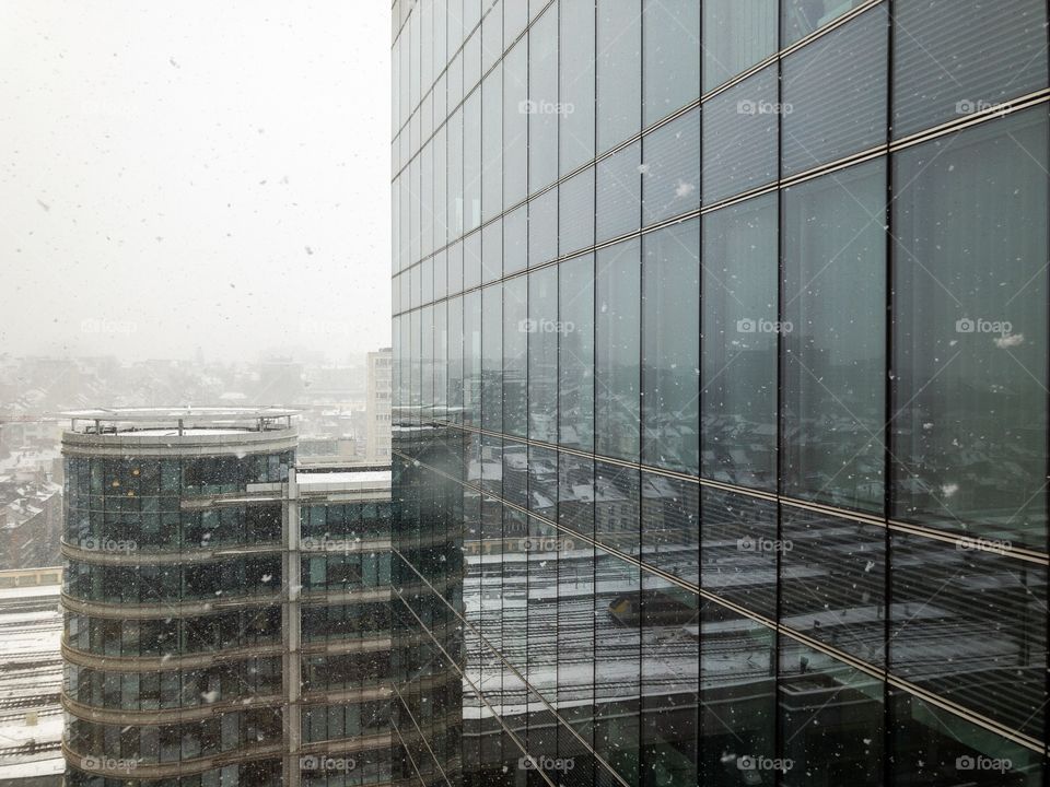 Snow falling over the city as seen from an of office building in the financial district.