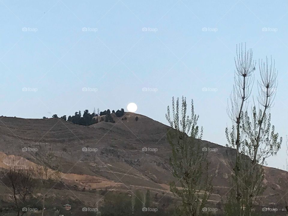 Full moon coming out behind from the mountain. . .residing in Kashmir 