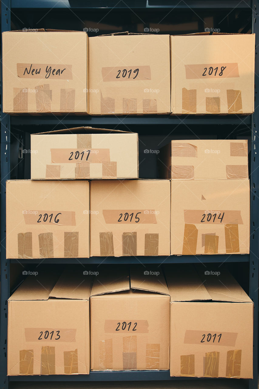 Cardboard boxes on shelves. Cardboard boxes labeled number of years on shelves
