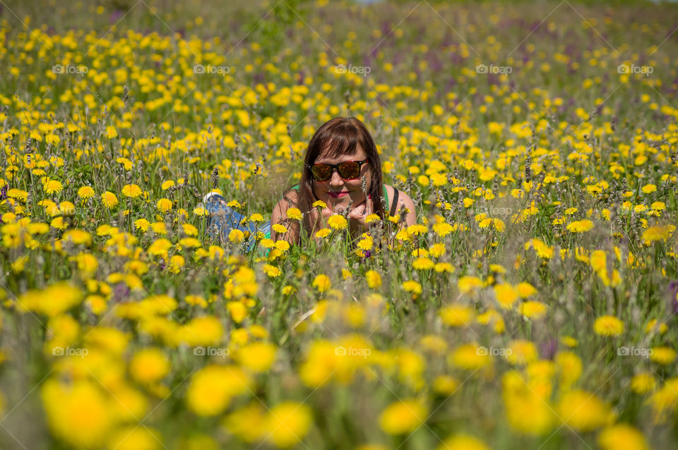 girl enjoys life in a dandelion field