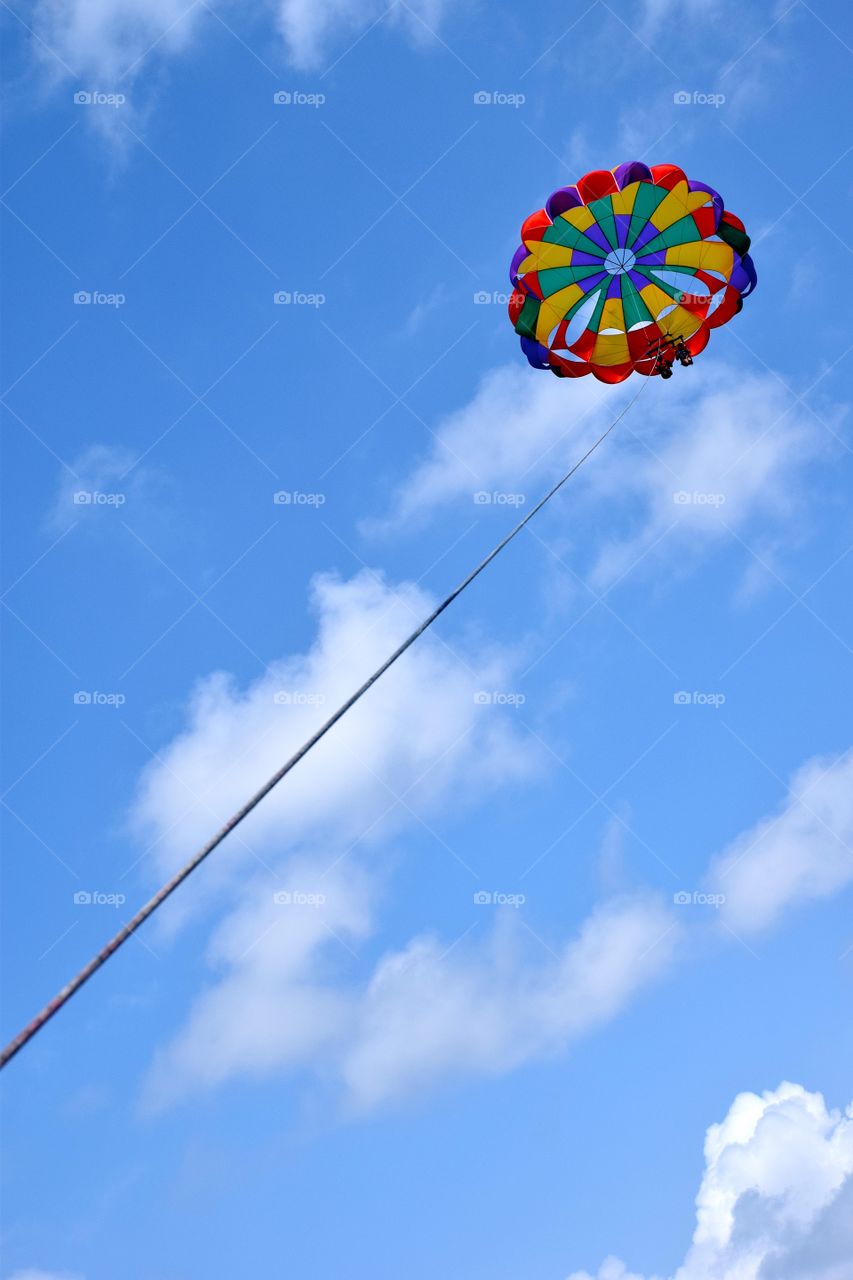 Couple flying with parasail