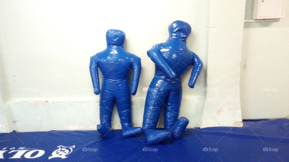 A pair of broken combat dummies in the gym leaned on the wall.