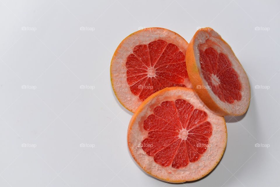 Slice of grapefruit on white background