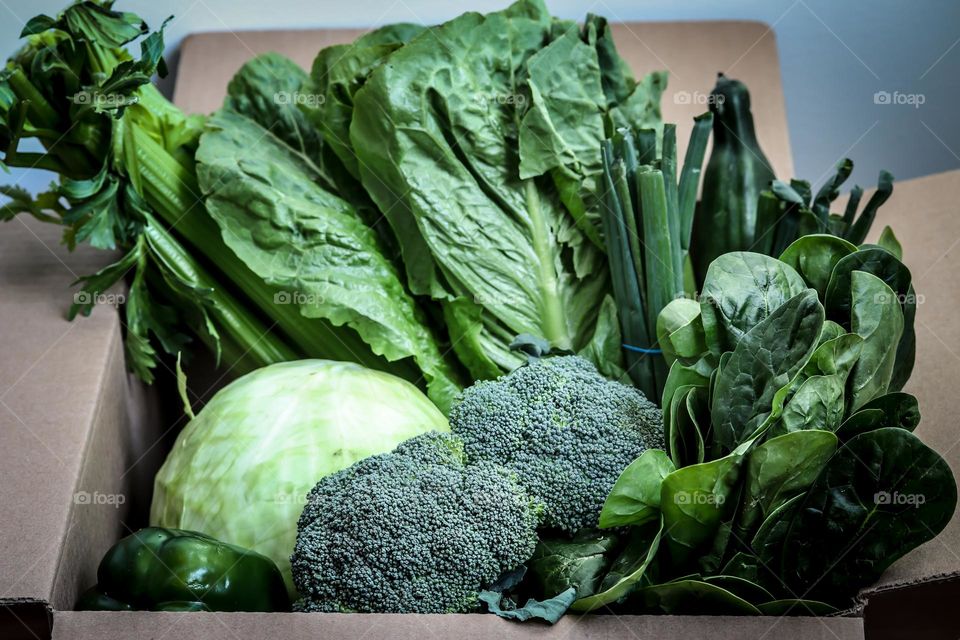 Green healthy vegetables in a cardboard box