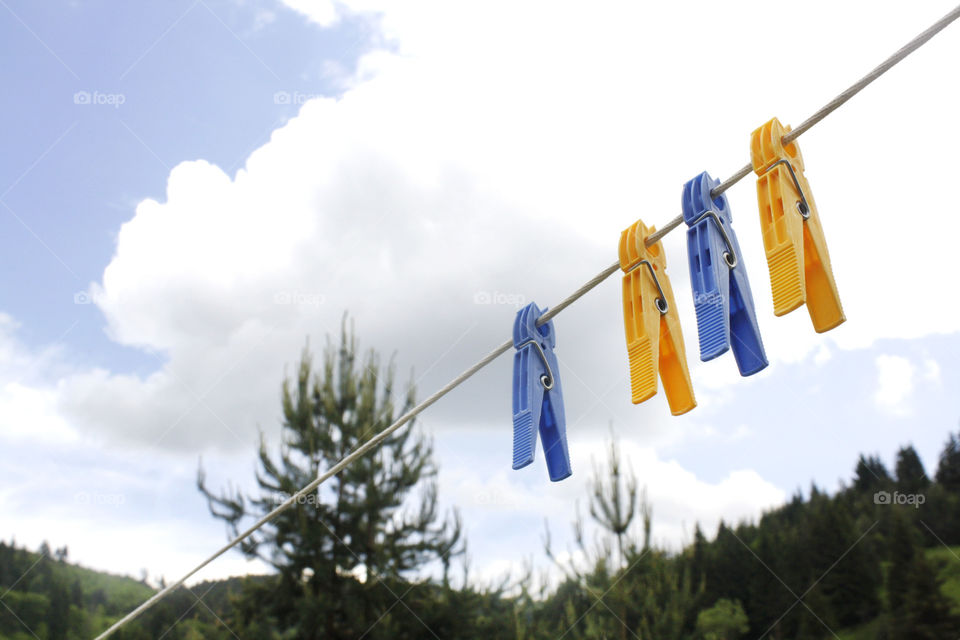 Clothespin and sky clouds