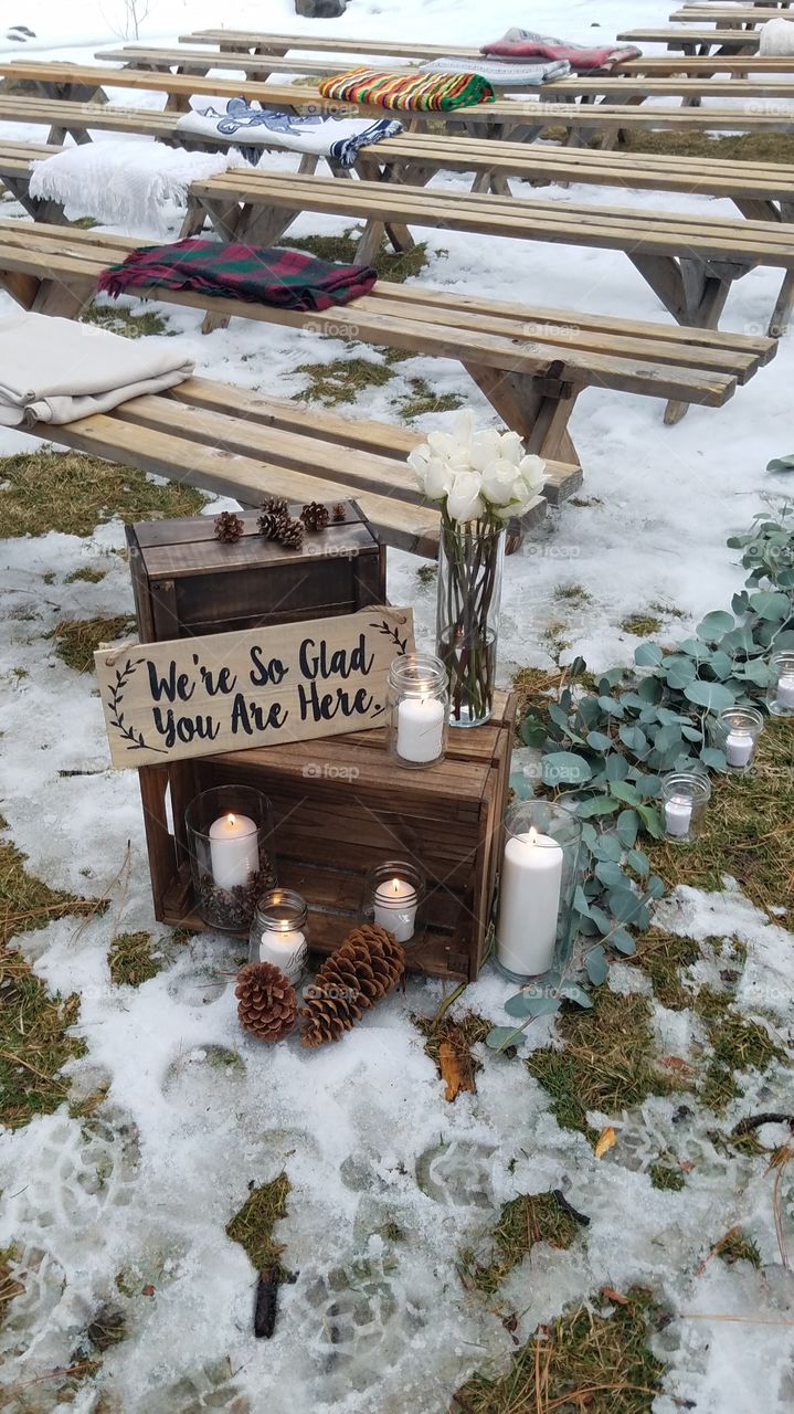 winter outdoor wedding aisle sign with Candles and flowers