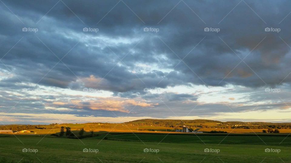 Honey kissed fields. As the storm clouds pass the land is honey kissed.