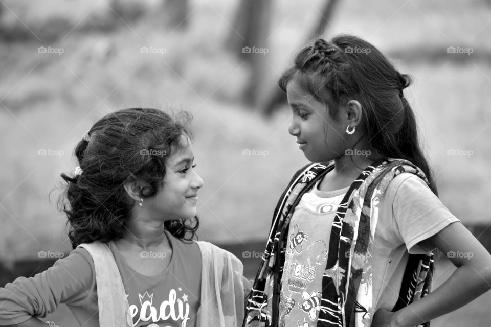 Joyfully sharing of smiles between two kids.