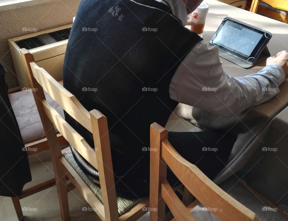 man having cold coffee frappe and surfing