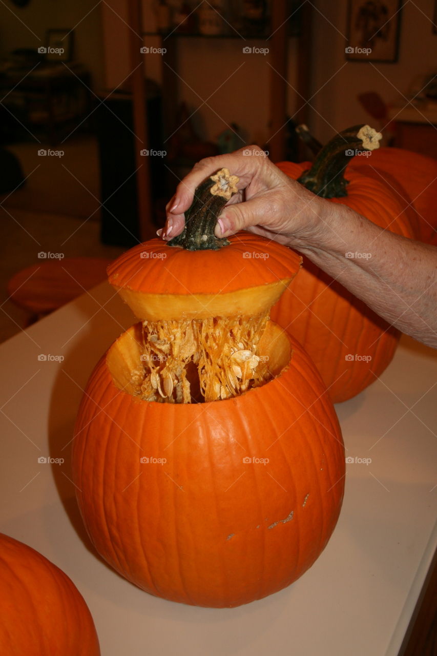 Removing seeds and cleaning out pumpkin
