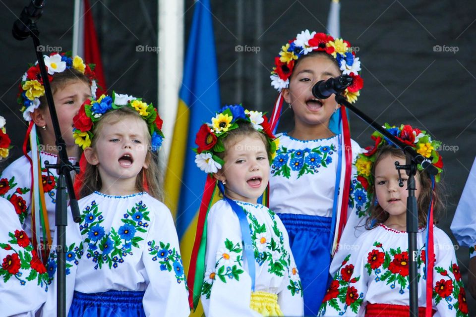 Girls in beautiful folk outfits are singing on an Ukrainian Independence day