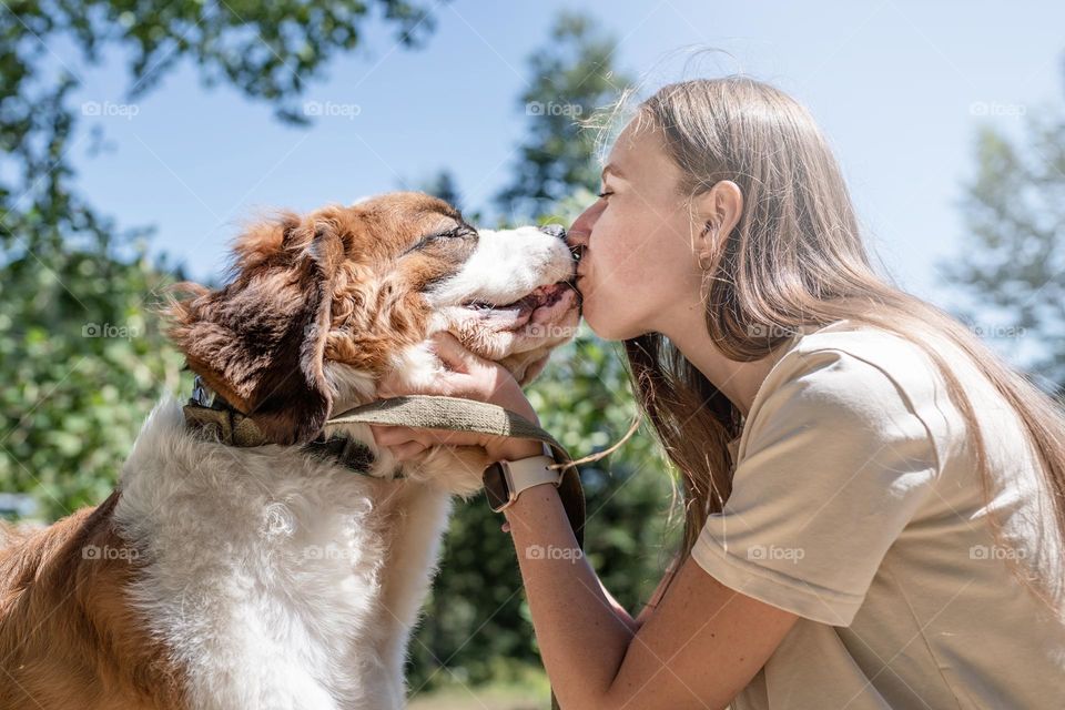 woman kissing her st Bernard dog