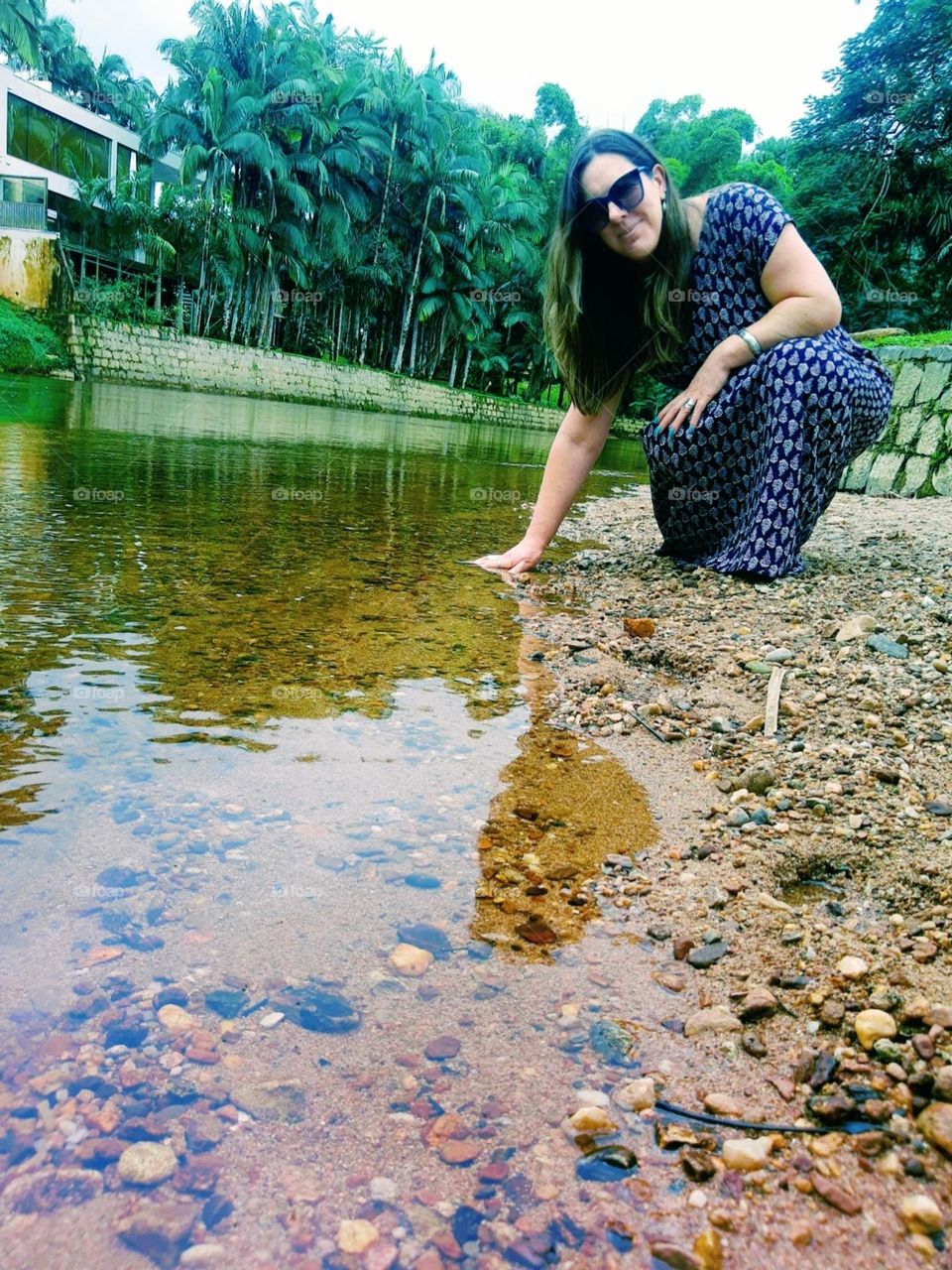 woman touching the river's water