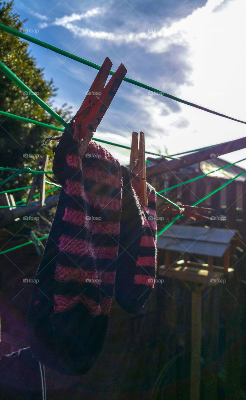 Pink and black socks on a washing line