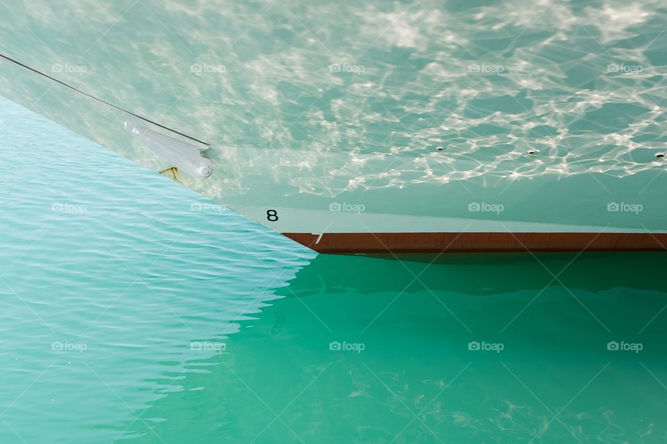 Prow boat reflections . Front part of a docked boat with water reflections 