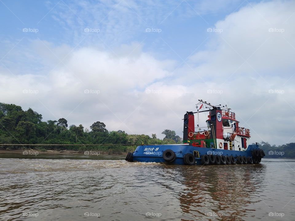 Tug boat on the Borneo river.