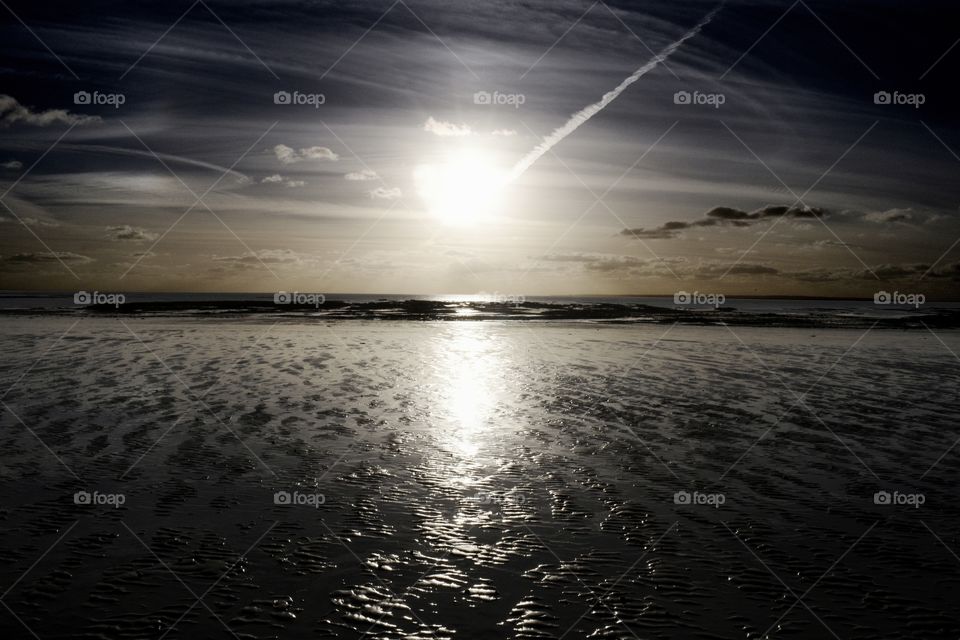 sunset on a low tide beach in winter