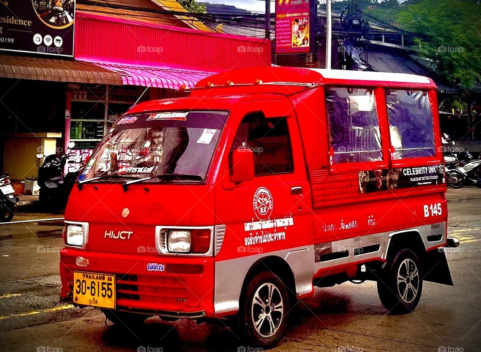 Bright red tuk tuk AMR Wozko