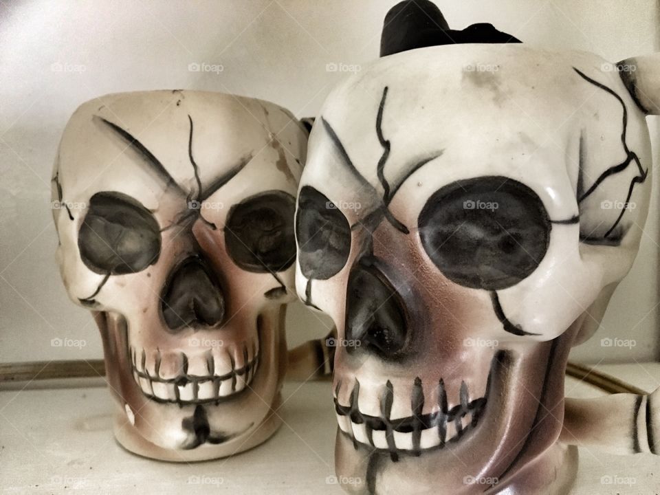 Vintage skull mugs passed down from my mother. They both have black candles inside and were out every year for Halloween since I was born 
