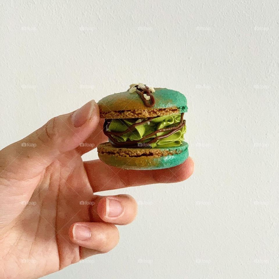 Holding onto Nutella matcha fat macaron. 